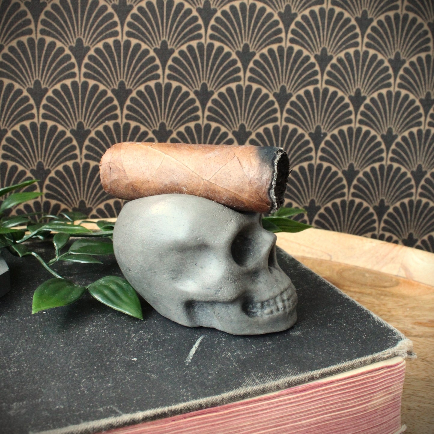 Side view of rustic luxury skull cigar rest cast in stone