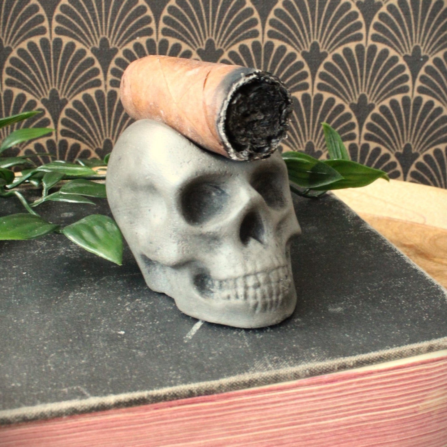 closeup of rustic luxury skull cigar stand cast in stone