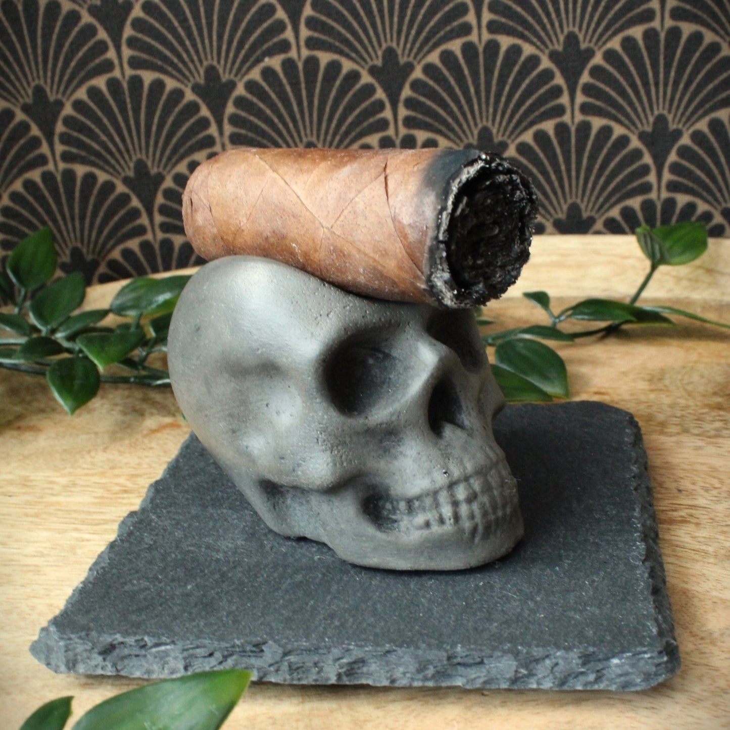 lifestyle shot: skull cigar rest on bar cart with lit cigar
