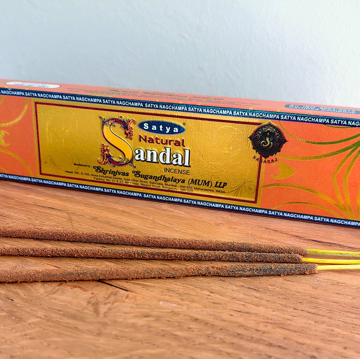 Close-up angled view of Satya Natural Sandal incense sticks with box in background