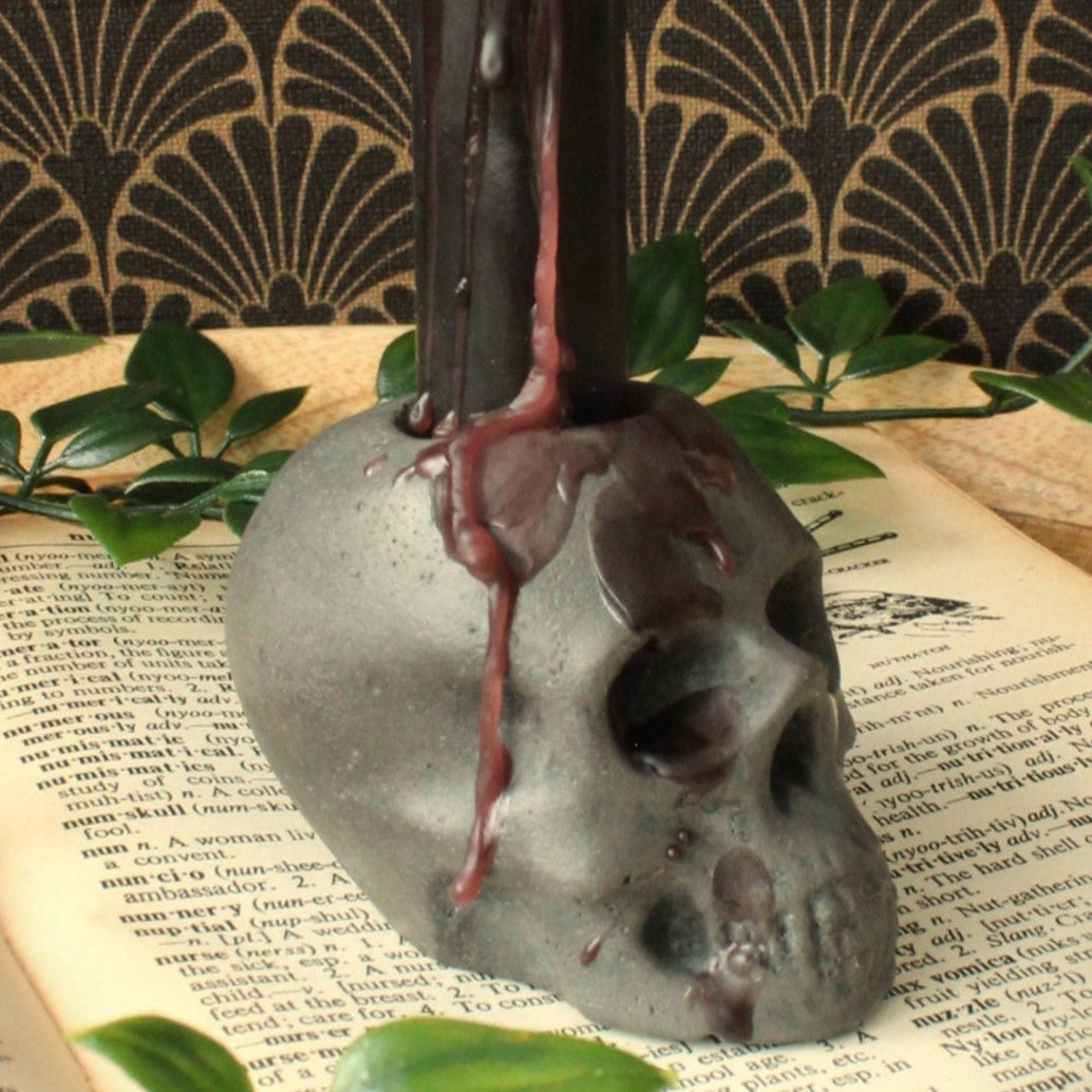 closeup shot of rustic skull candle holder cast in stone