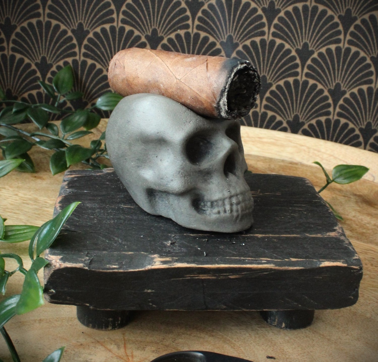 Grey stane, skull shaped cigar rest. With cigar in place