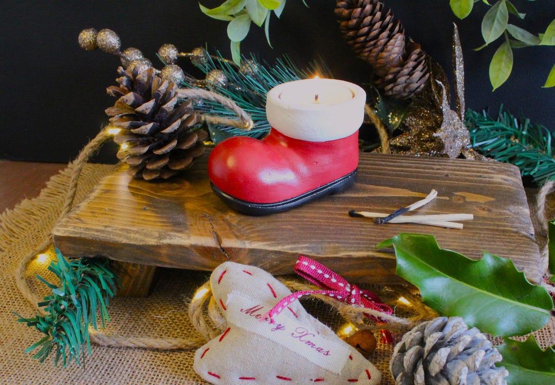 Santa boot tea light holder with a lit candle