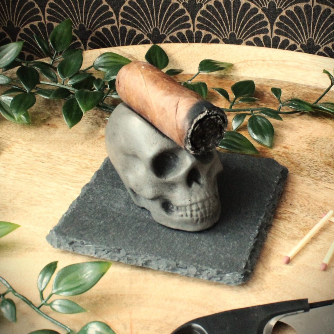 closeup of rustic luxury skull cigar rest cast in stone